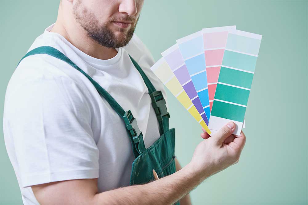 person with paint swatches