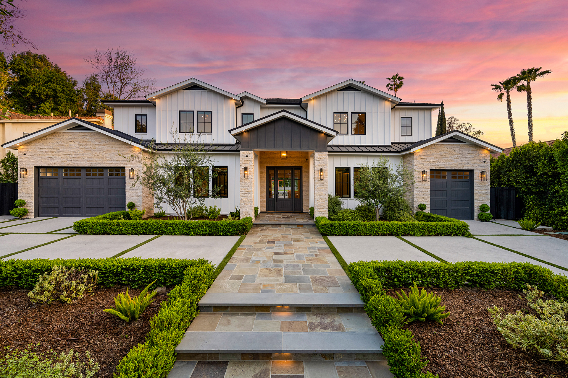 beautiful landscaped yard with hedging and small trees